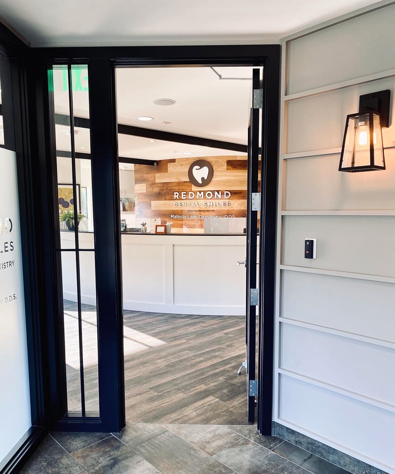 Glass entry doors opening onto the Redmond Dental Smiles reception area